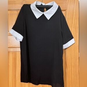 Black top with white collar and white trim on sleeves